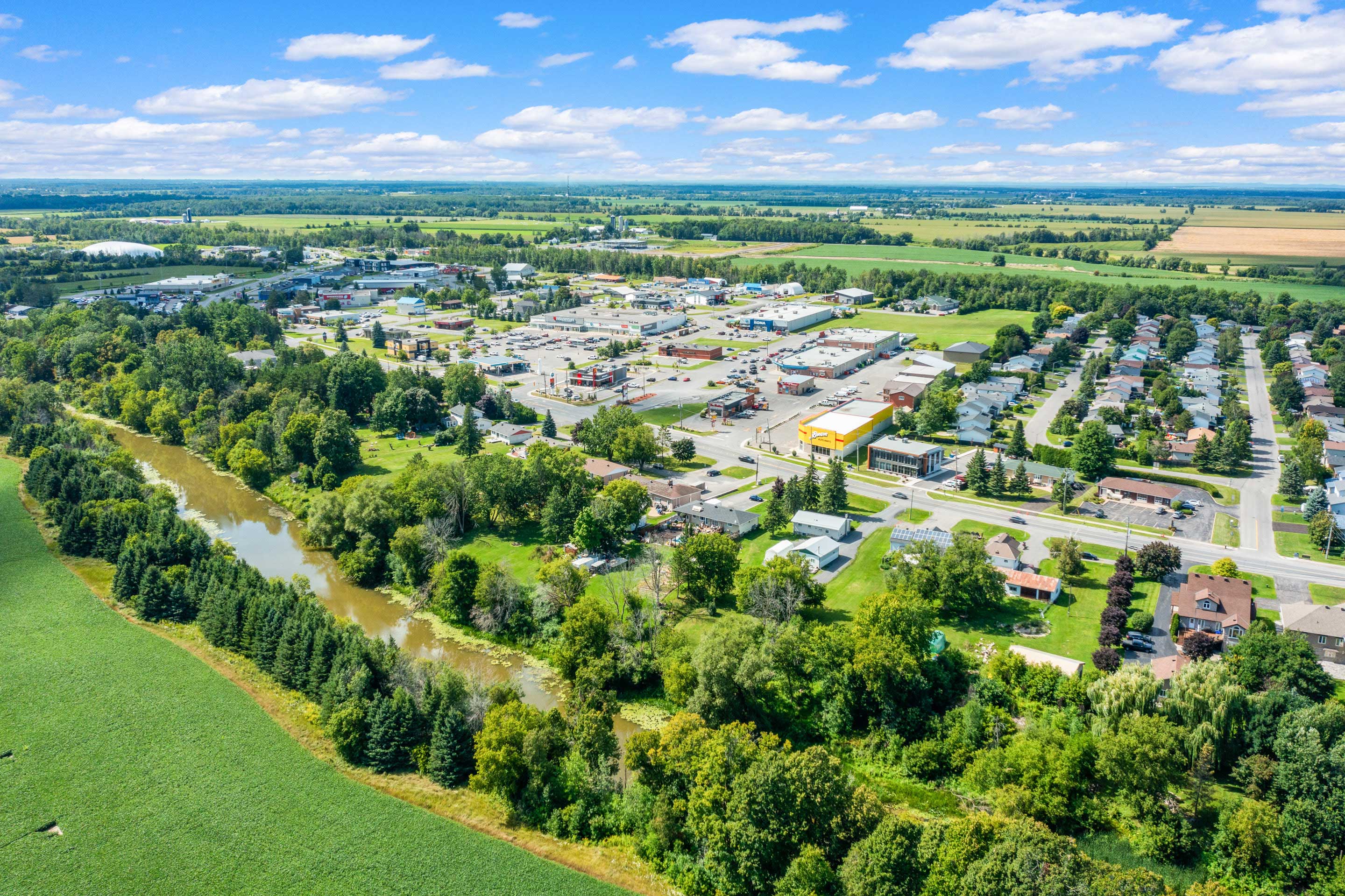 Aerial view of Embrun with river, shops, and residential neighbourhoods near Panorama